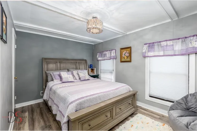 a bedroom with a bed and a chandelier