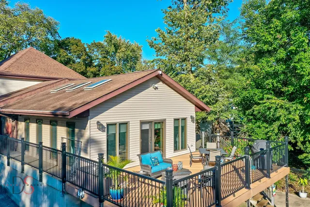 a view of a house with backyard and sitting area