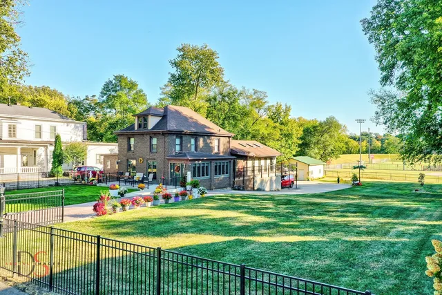 a front view of house with outdoor seating and yard