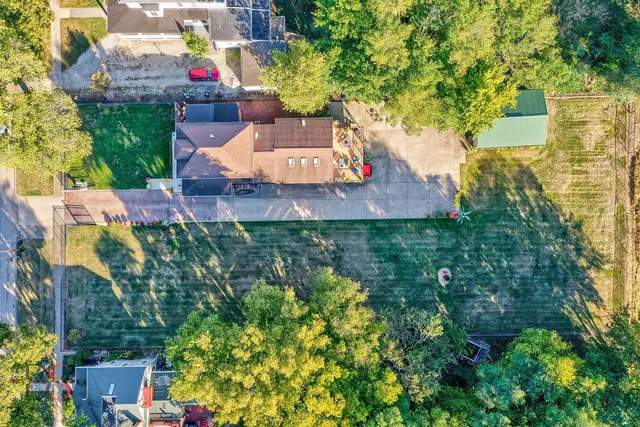 an aerial view of a house with a yard and garden