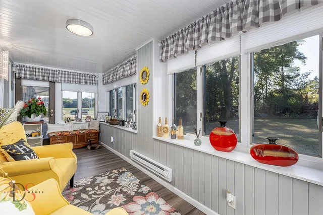 a living room with furniture and a floor to ceiling window