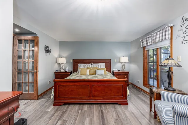 a bedroom with a bed and wooden floor