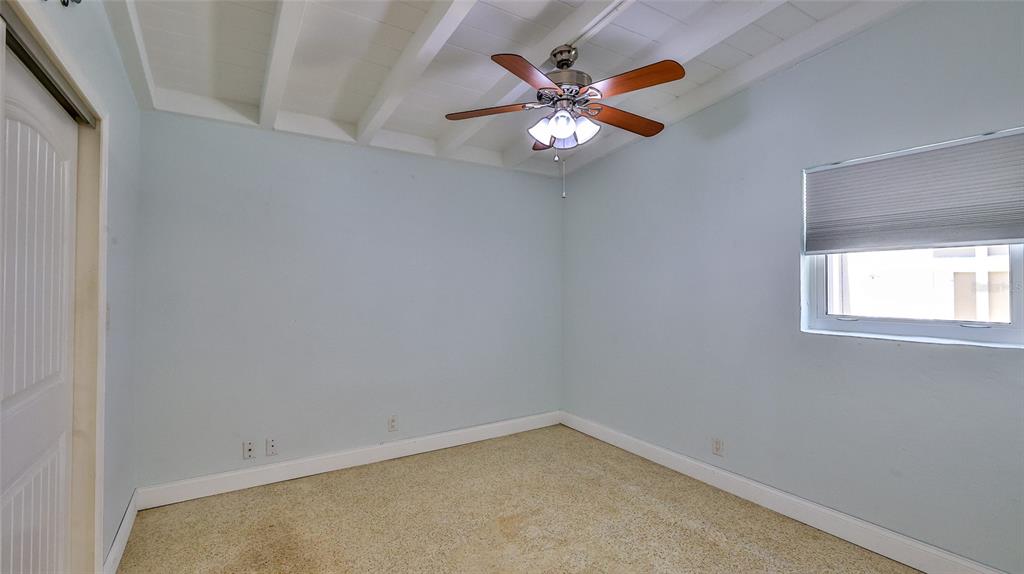 8 Ocean Dunes Drive Ormond Beach, FL 32176 - Photo 18 of 55 an empty room with windows and chandelier fan