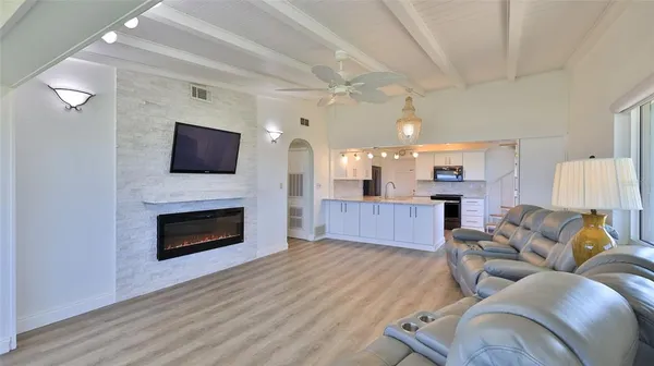 a kitchen with stainless steel appliances granite countertop a sink dishwasher stove and wooden floor
