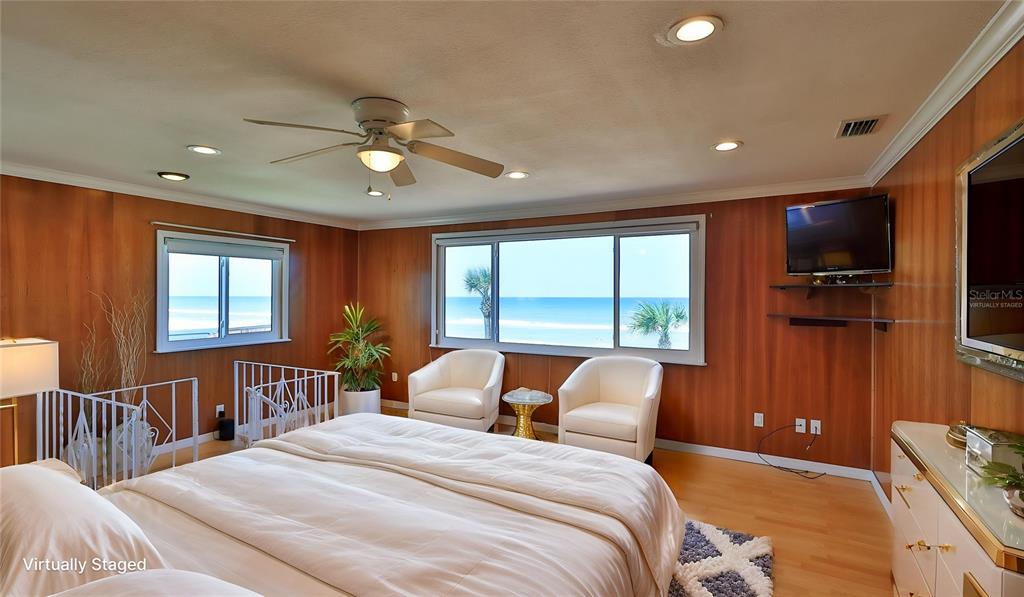 8 Ocean Dunes Drive Ormond Beach, FL 32176 - Photo 23 of 55 a bedroom with a bed a flat screen tv and a large window