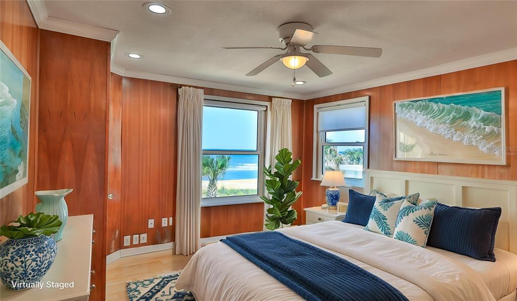 8 Ocean Dunes Drive Ormond Beach, FL 32176 - Photo 30 of 55 a bedroom with a large bed and a chandelier
