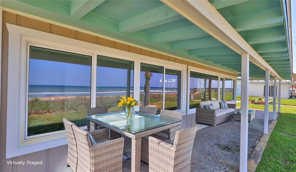 8 Ocean Dunes Drive Ormond Beach, FL 32176 - Photo 39 of 55 a view of a patio with table and chairs and potted plants