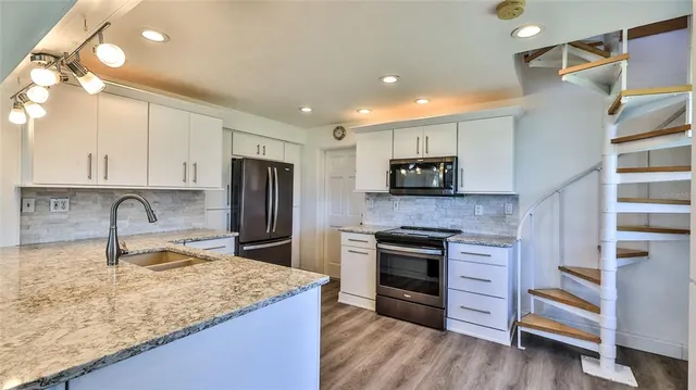 a living room with furniture and chandelier