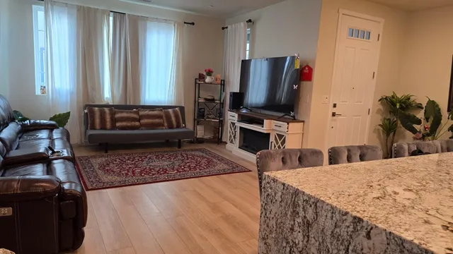 a living room with furniture and potted plant