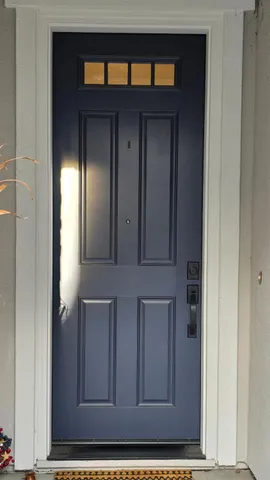 a view of a brick house with potted plants and a table and chairs