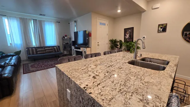 a living room with furniture rug and a window