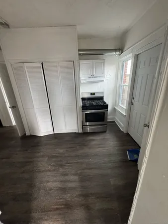 a view of kitchen with wooden floor and electronic appliances
