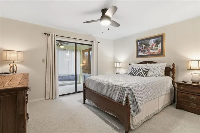 a spacious bedroom with a bed and a chandelier