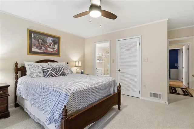 a bedroom with bed and a chandelier