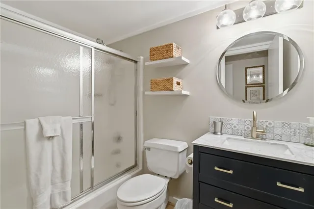 a bathroom with a toilet a sink and a mirror