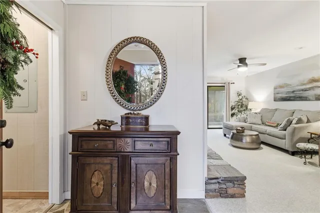 a view of living room with furniture and a mirror