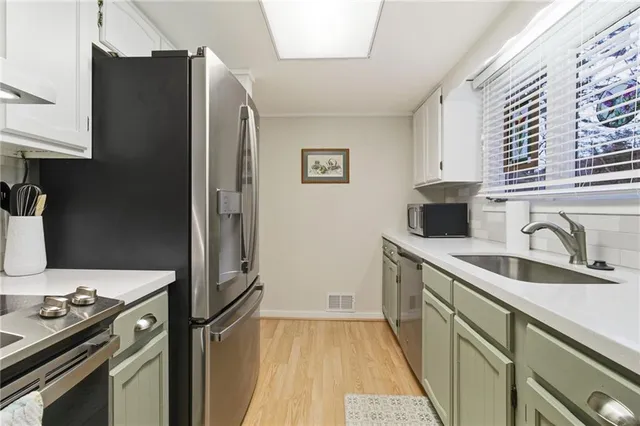 a kitchen with a sink stove and refrigerator