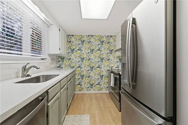 a bathroom with a granite countertop sink a vanity and a shower