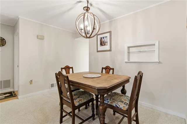 a view of a dining room that has a table and chairs in it