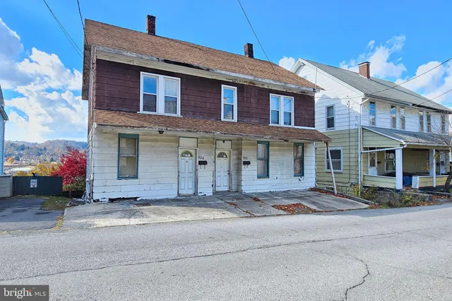 a front view of a house with yard