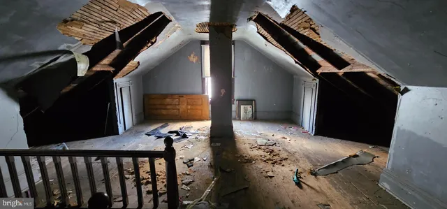a room with water heater and a wooden door