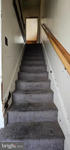 a view of an empty room with window and bathroom