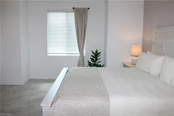 a bed room with a bed and a window