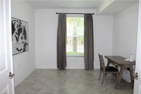a view of a livingroom with furniture and a window
