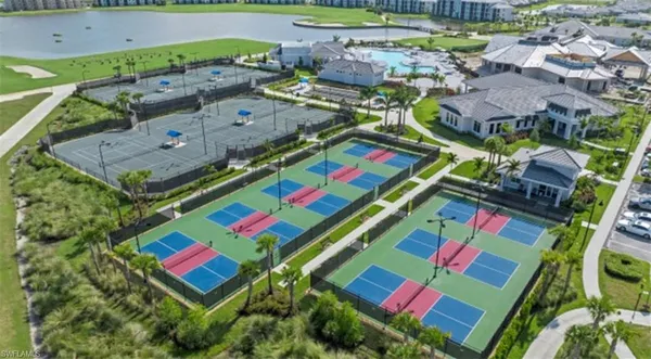 an aerial view of a tennis ground and a yard