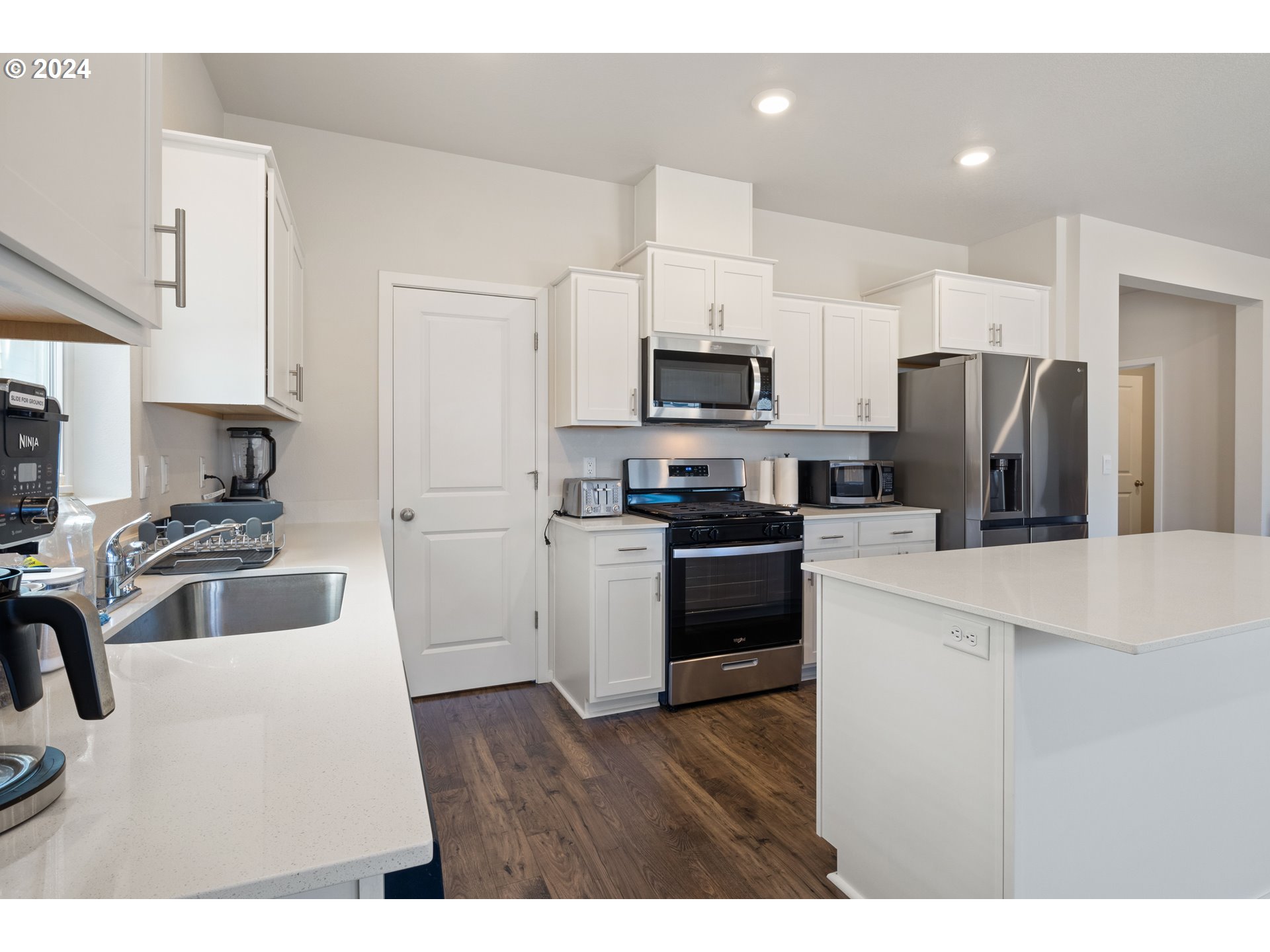 2898 V Street Springfield, OR 97477 - Photo 13 of 47 a kitchen with kitchen island a sink stainless steel appliances and cabinets