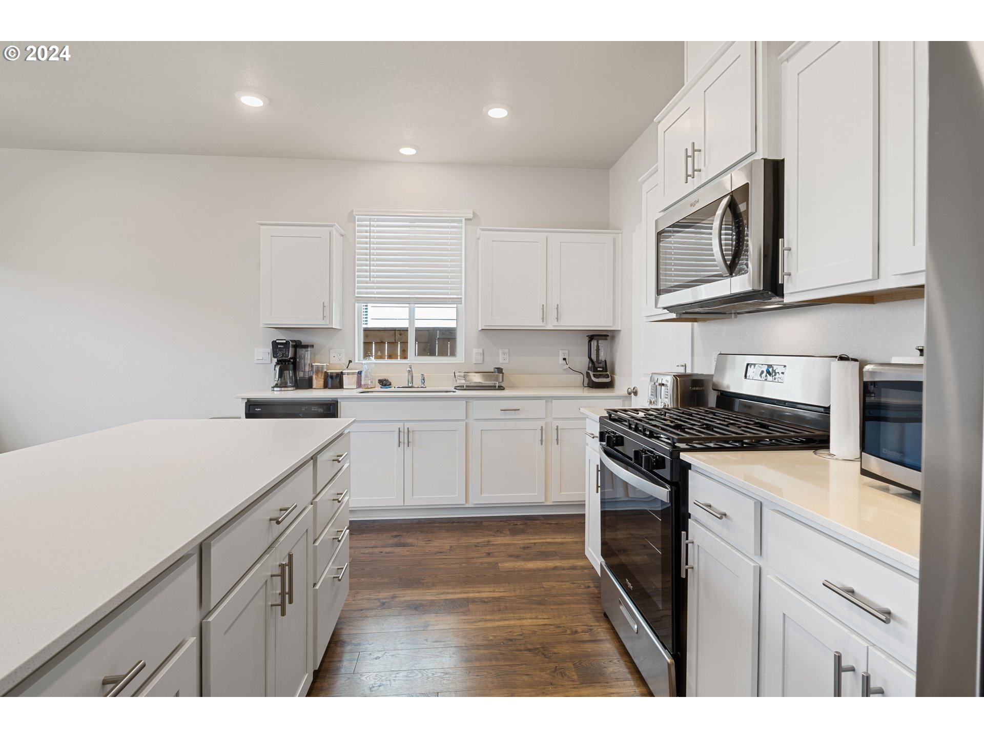 2898 V Street Springfield, OR 97477 - Photo 16 of 47 a kitchen with stainless steel appliances granite countertop a sink a stove a microwave and cabinets