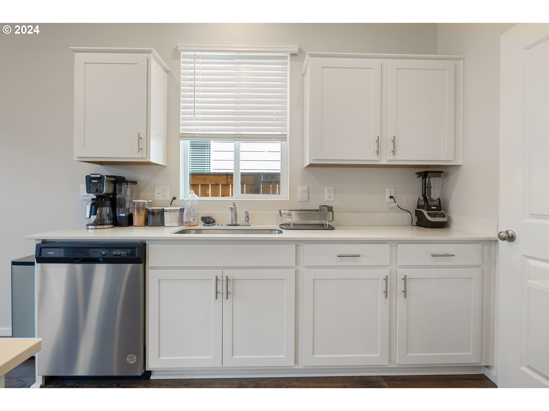2898 V Street Springfield, OR 97477 - Photo 18 of 47 a kitchen with stainless steel appliances granite countertop a sink a stove and white cabinets