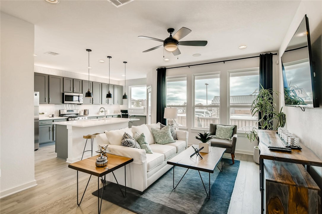 a living room with kitchen island furniture and a large window