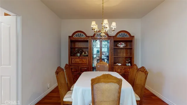 a view of a dining room with furniture and chandelier