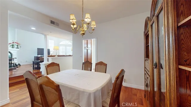 a view of a dining room with furniture and chandelier