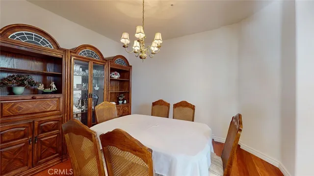 a view of a dining room with furniture and chandelier