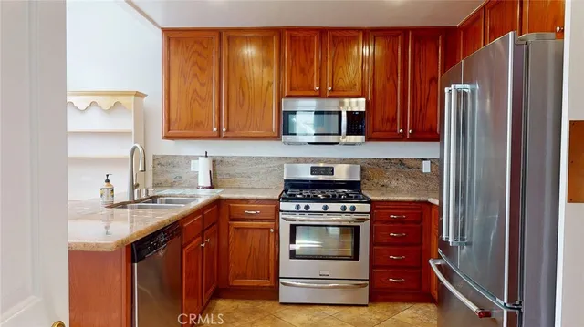 a kitchen with a stove a refrigerator and a sink