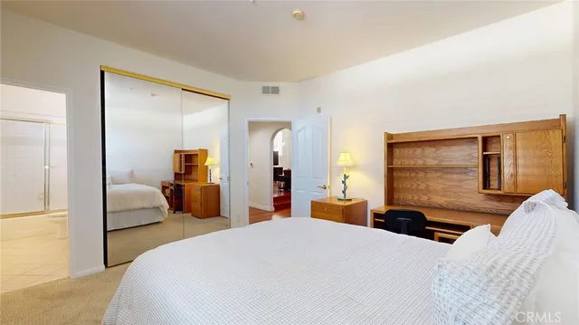 a bedroom with a bed and a couch