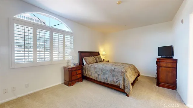 a bedroom with a bed and a television