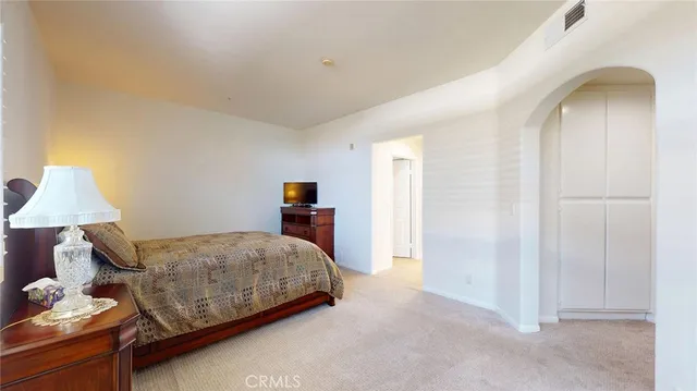 a bedroom with a bed and a lamp