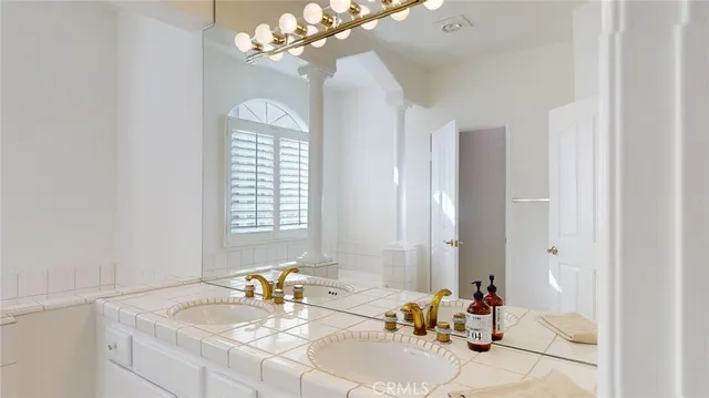 a bathroom with a tub sink and mirror
