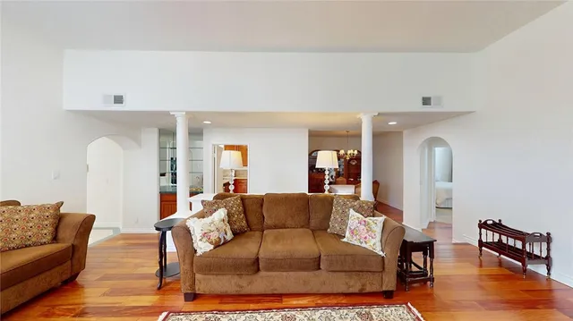 a living room with furniture and wooden floor