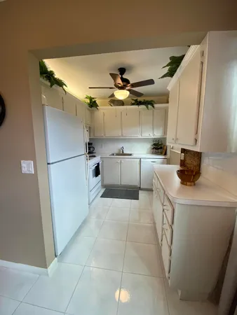 a kitchen with a sink appliances and cabinets