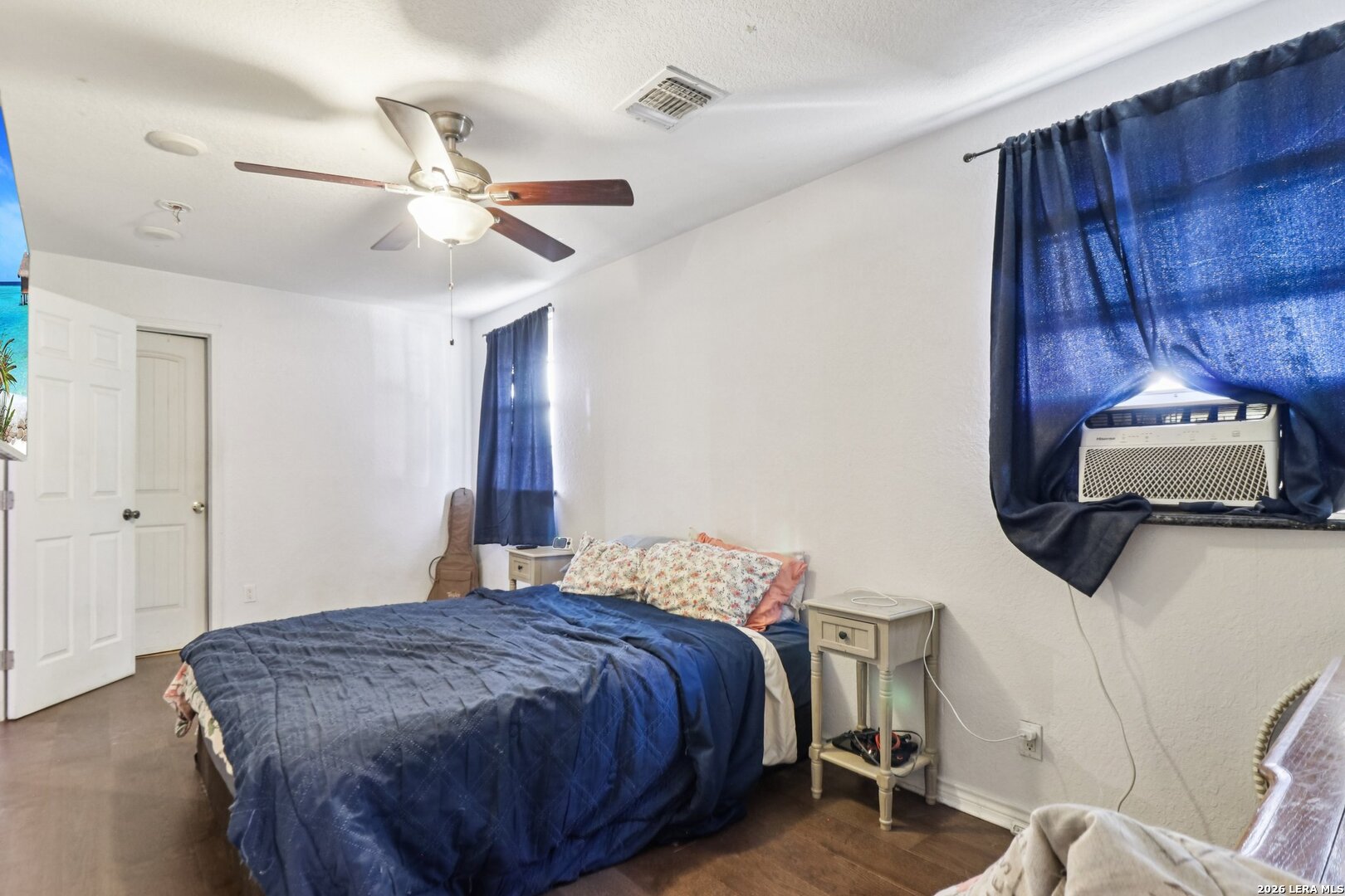 215-213 Coughran Road Pleasanton, TX 78064 - Photo 10 of 13 a bedroom with a bed and a mirror on the dresser