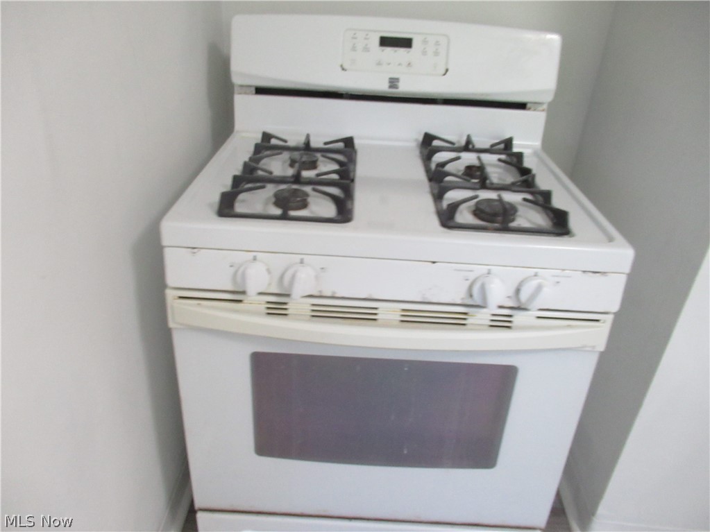 5095 Edenhurst Road Lyndhurst, OH 44124 - Photo 23 of 24 White freestanding gas range with a four-burner cooktop