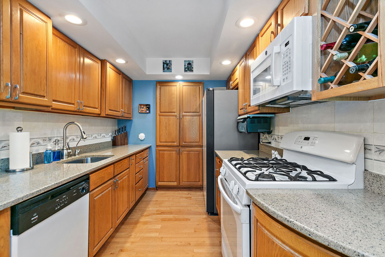 632 Bridgeview Point Schaumburg, IL 60194 - Photo 5 of 25 a kitchen with stainless steel appliances granite countertop a stove a sink dishwasher and refrigerator with wooden cabinets