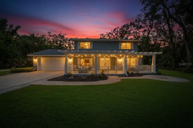 a view of a house with a yard and a patio