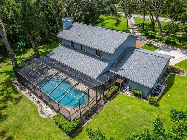 an aerial view of a house with a yard
