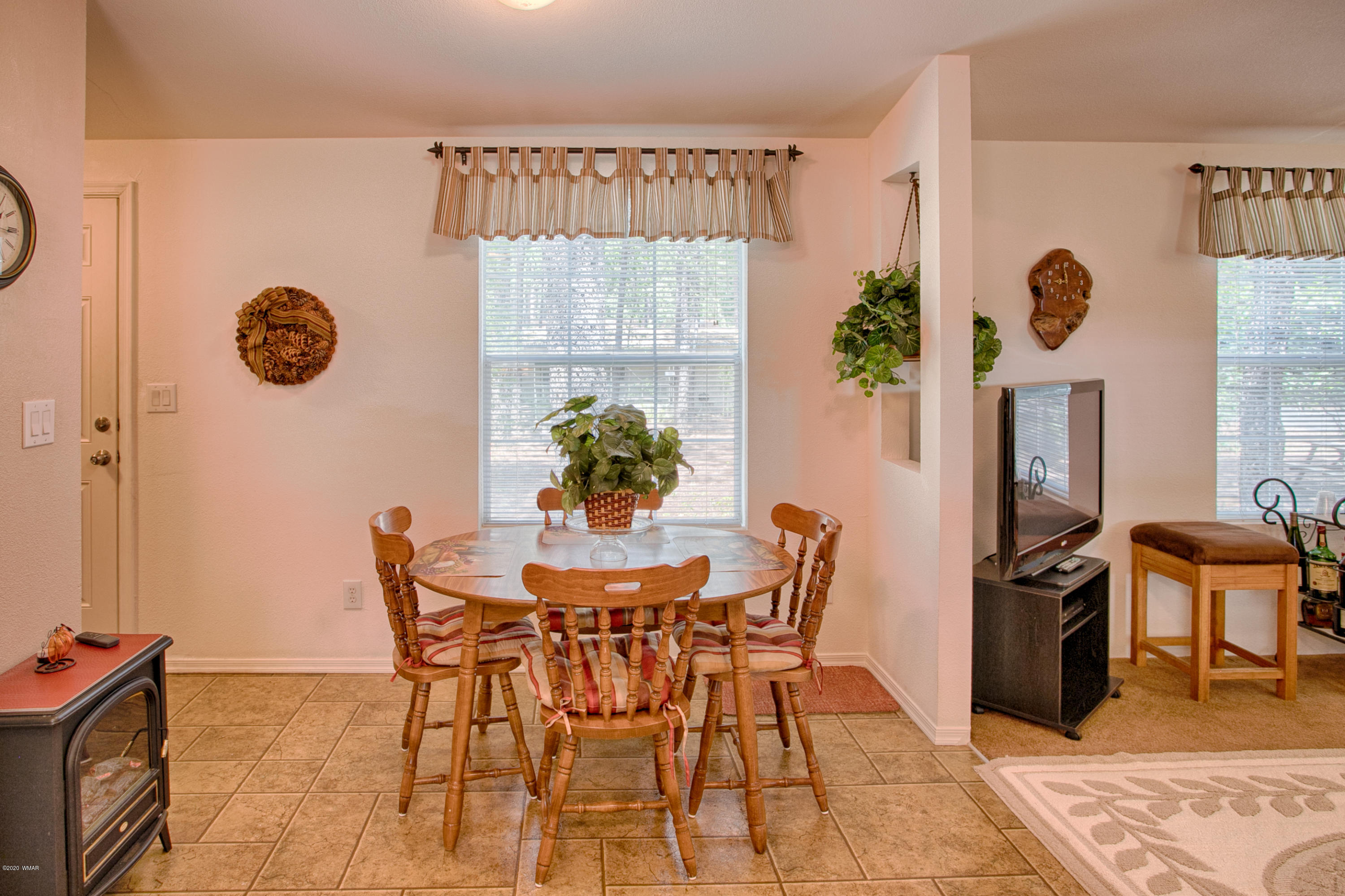4192 West Blue Ridge Loop Pinetop, AZ 85935 - Photo 8 of 14 a view of a dining room with furniture and chandelier