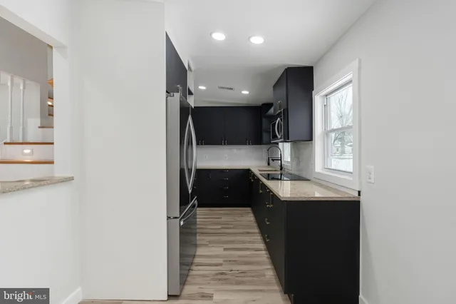 a kitchen with a sink and a refrigerator